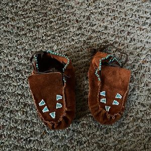 Brown suede beaded infant moccasins.